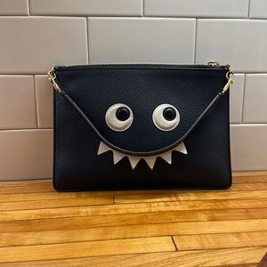 Eyes clutch wristlet with teeth handle